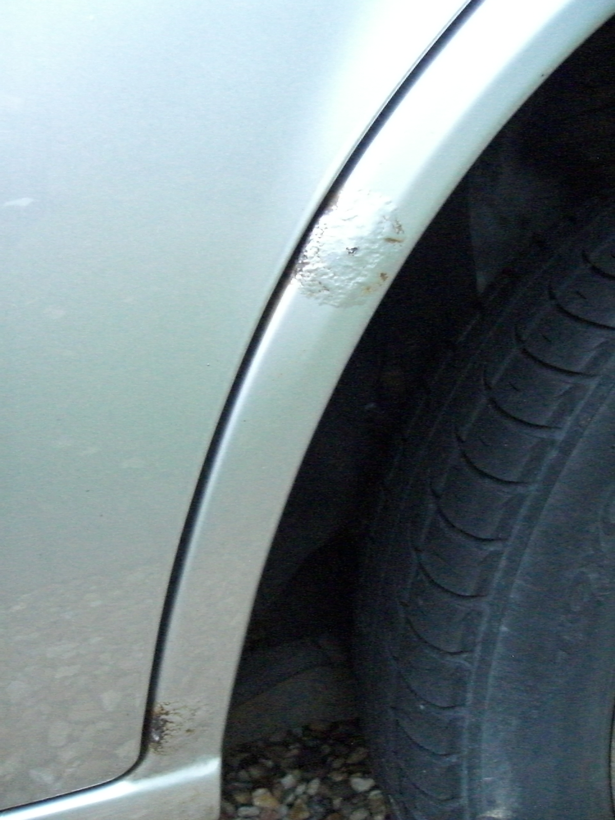 Rusty wheel arch of Ford Fiesta 1.3 1997